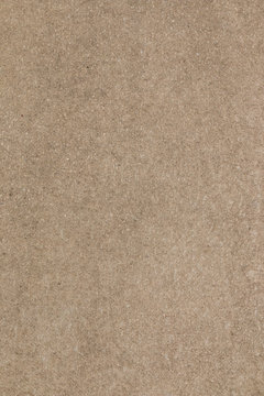 Brown concrete floor texture. Close-up photo of scabrous background. Vertical orientation