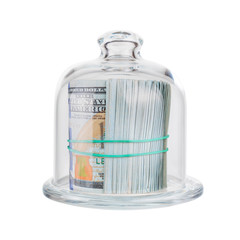 Wad of cash held together by an elastic band under a glass cap