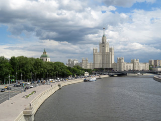 Fototapeta na wymiar Moscow river and Stalin high-rise building in the center of the Russian capital. Moscow center panorama at daytime on background of cloudy sky