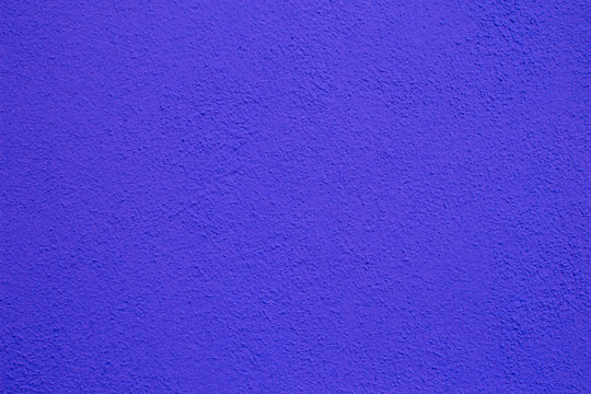 Purple wall background. Painted rought concrete surface texture