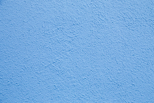Blue wall background. Painted rought concrete surface texture