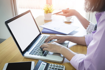 Mockup image of two businesswomen working together on laptop in office