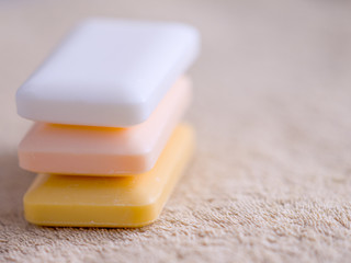 three bars of soap on a towel