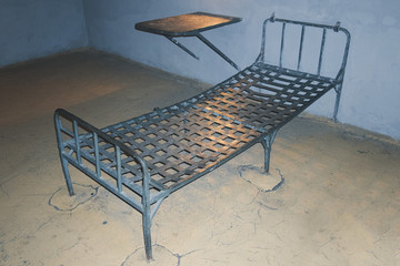 An old prison cell, an iron bed and a table