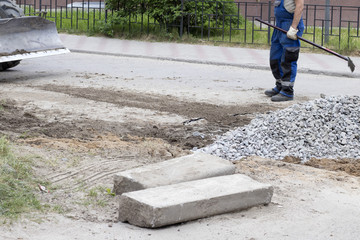 Road works on closing holes in the road in summer