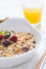 Freshly Prepared Muesli With Milk, Chia Seeds, Berries and Cinnamon. Bright Sunny Morning with Healthy Breakfast.