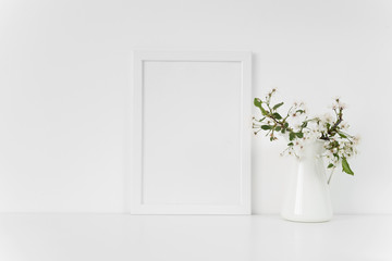 White Frame mock up A5 with spring cherry bouquet. Mock up for your photo, design or text.