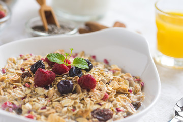 Freshly Prepared Muesli With Milk, Chia Seeds, Berries and Cinnamon. Bright Sunny Morning with Healthy Breakfast.