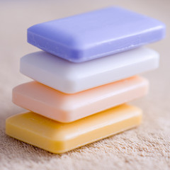 four bars of soap on a towel