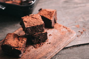 Decadent moist dark chocolate stout beer brownies cut in squares. Dark food photography concept