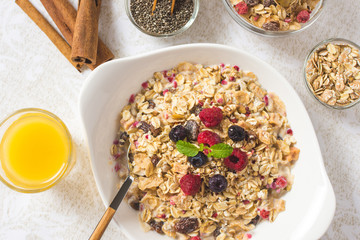 Freshly Prepared Muesli With Milk, Chia Seeds, Berries and Cinnamon. Bright Sunny Morning with Healthy Breakfast.