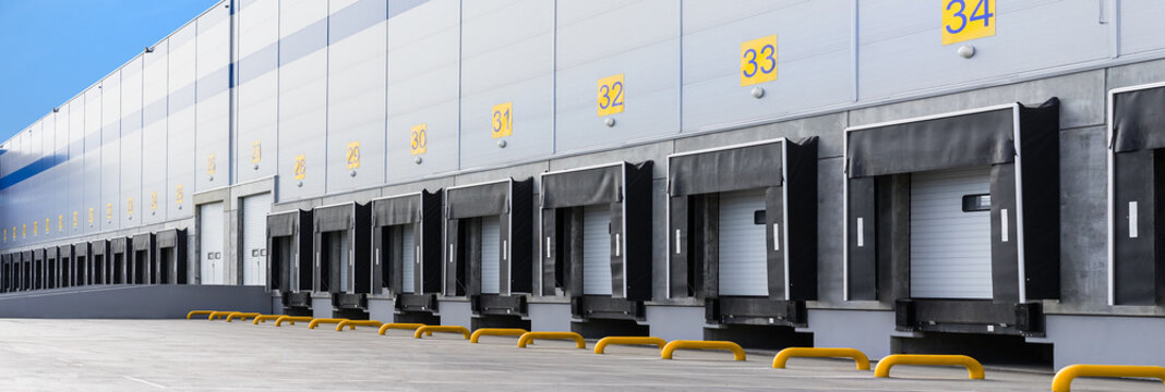 Fototapeta Entrance ramps of a large distribution warehouse with gates for loading goods