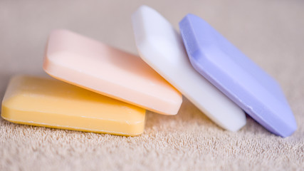 four bars of soap on a towel
