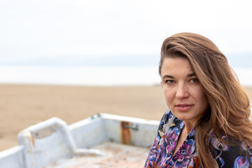 Fototapeta na wymiar Ukrainian woman with colorful dress and print on the beach