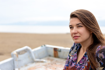 Fototapeta premium Ukrainian woman with colorful dress and print on the beach