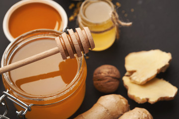 Various types of honey on wooden platter, closeup