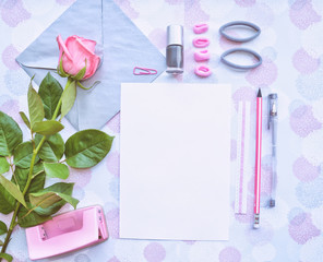 Obraz na płótnie Canvas Blank paper, envelope, stationery, badges, hair bands, pink rose, pens and pencils. Pink and gray mockup