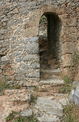 The arc with steps in the old stone wall of the Venetian fortress on the small Mediterranean island Spinalonga near Crete. 