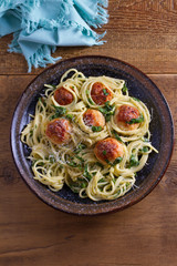 Spaghetti with spinach and chicken meatballs. Pasta with meatballs. View from above, top studio shot
