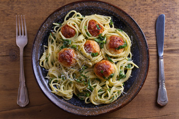 Spaghetti with spinach and chicken meatballs. Pasta with meatballs. View from above, top studio shot