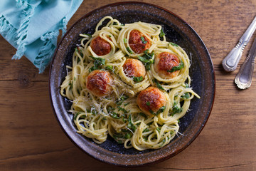 Spaghetti with spinach and chicken meatballs. Pasta with meatballs. View from above, top studio shot