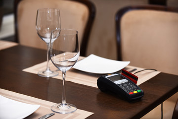 EDC machine or bankcard in reader on table in restaurant