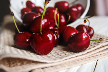 delicious ripe cherries scattered on the kitchen towel