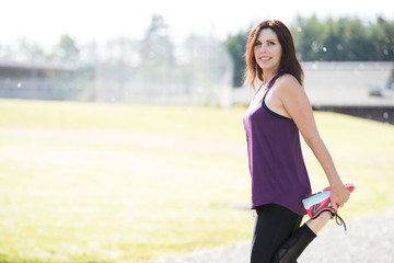 Healthy active woman stretching her legs