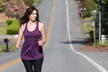 Strong woman running uphill