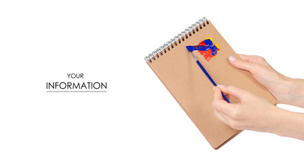 Notepad for drawing and paint brush in hand pattern on white background isolation