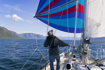 Flying a colorful spinnaker on a seaworthy sailing yacht