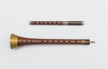 Zurla and wooden pipe. Isolated image of traditional Serbian musical instruments.