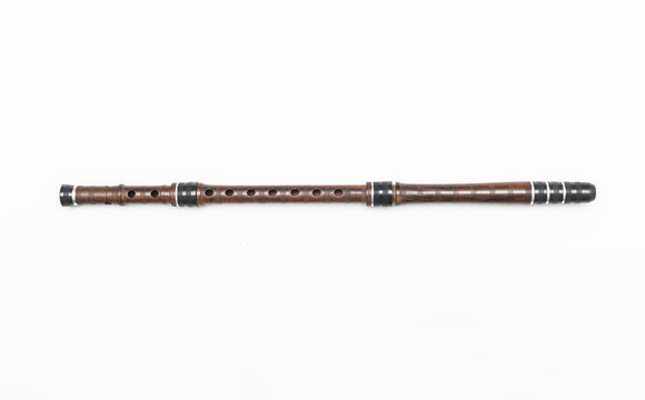 Traditional Serbian long pipe musical instrument. Isolated image of woodwind flute on white background.