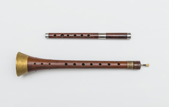 Zurla and wooden pipe. Isolated image of traditional Serbian musical instruments.