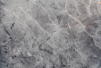 Fototapeta premium Fragment of stone texture with scratches and cracks. Natural Background.