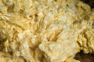 Soft raw threads extracted from the cocoon of the silkworm in processing