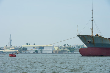 Naklejka premium KAOHSIUNG, TAIWAN - CIRCA June, 2018:A large cargo ship moves towards the exit of Kaohsiung harbor
