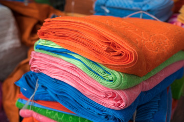Big pile of colorful towels at production place