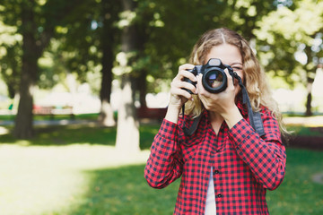 Woman taking photos while standing in the park