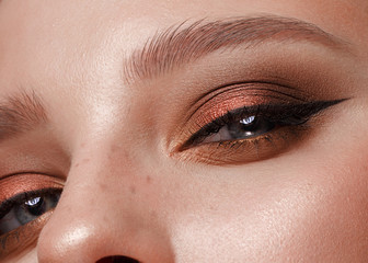 Closeup shot of female eye with color eyes shadows and eyelashes makeup