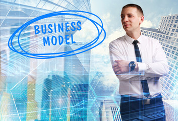 The concept of business, technology, the Internet and the network. Young businessman showing inscription: Business model