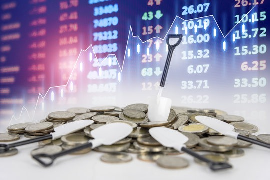 Profit money shovel up for investment with stock market electronic board background