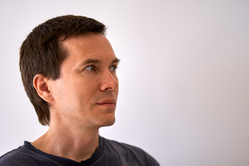 Fototapeta premium Man looking to the empty space for your text on the side of the