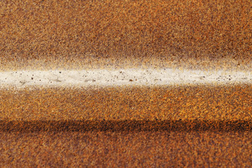 Old rusty metal corrugated sheet with iron oxides. Grunge texture background