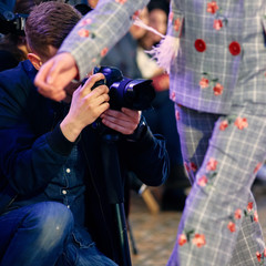 Professional photographer working at fashion week on presentation of new collection