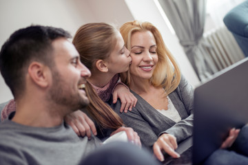 Family using laptop together at home
