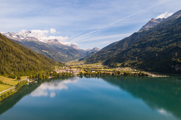 Naklejka na ściany i meble Swiss Alps, lake and village of Poschiavo. Aerial shot. 