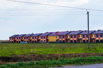 Fototapeta na wymiar range of houses among the field