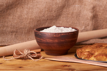apricot pie and a bowl with flour and other ingredients and tools table