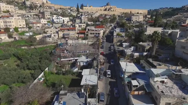 Aerial view fly over Jerusalem alleys and villages, towards Temple mount mosque, Western wall.